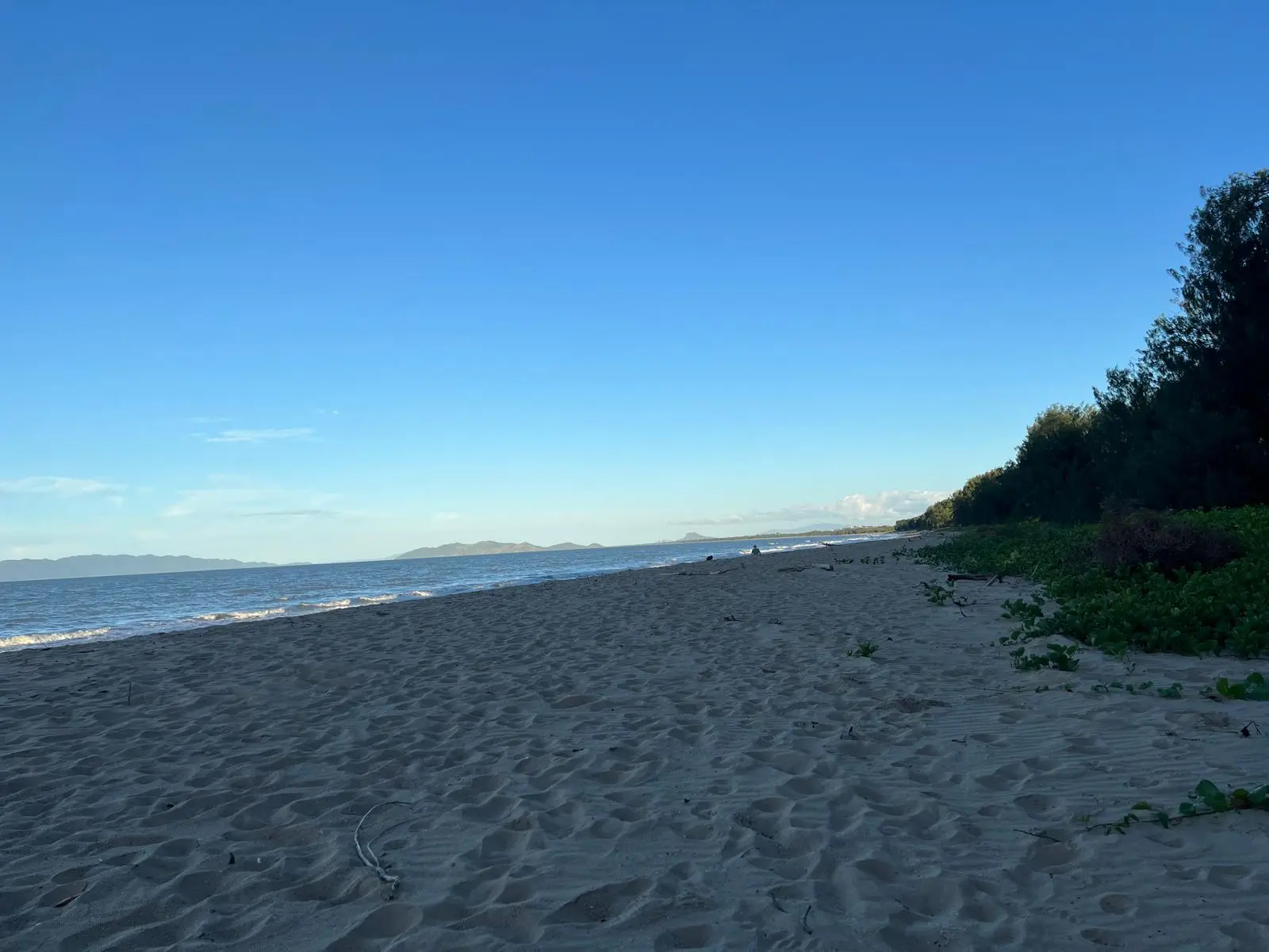 Wide landscape view of Saunders Beach Townsville under clear blue Dry Season skies.