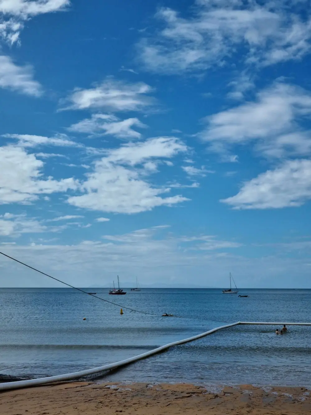 Stinger net floats marking a seasonal swimming enclosure on a Townsville beach